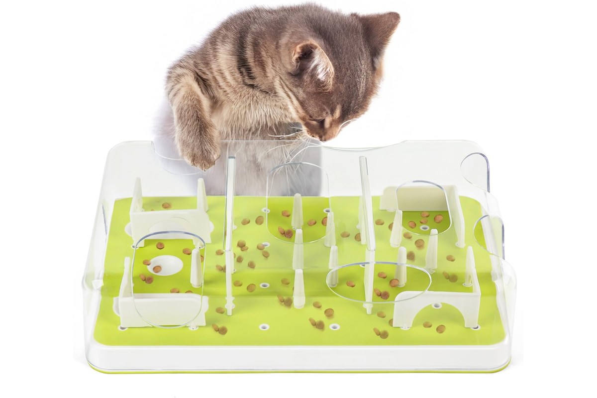 An interactive cat puzzle feeder with sliding lids, tracks and covered treat compartments