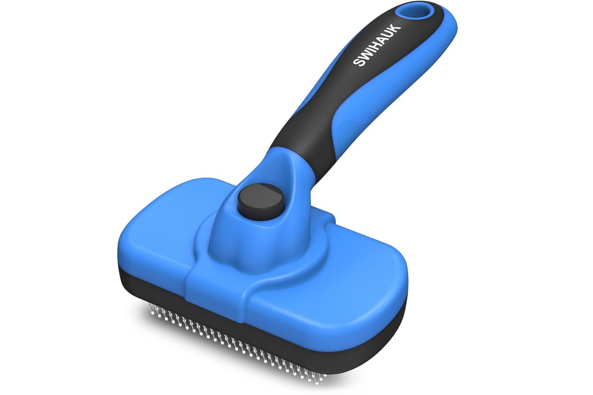A self-cleaning slicker brush for cats with fine angled bristles and a non-slip handle